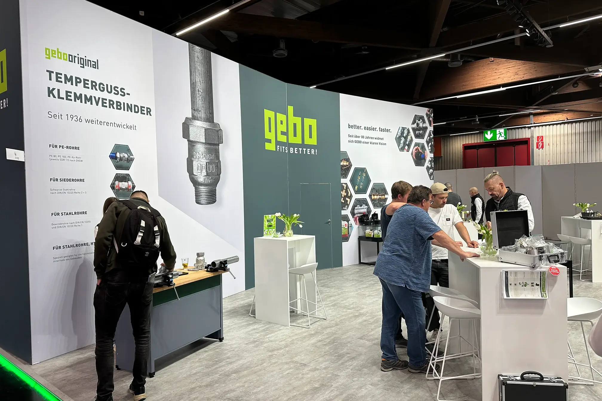 GEBO exhibition booth showcasing temperguss clamp connectors and pipe fittings at trade fair