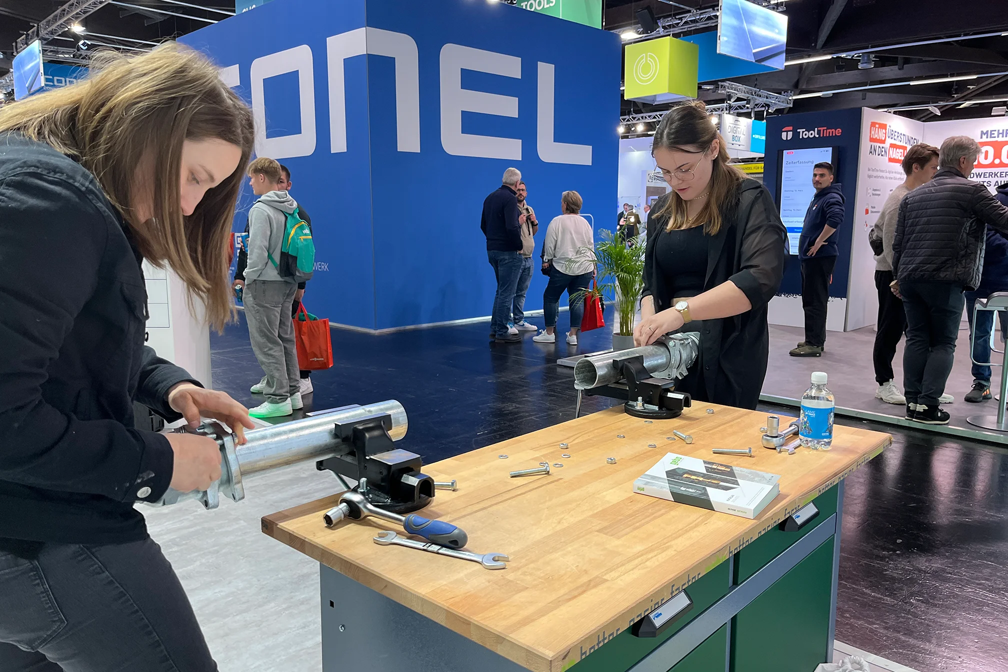 Visitor at GEBO trade fair booth examining pipe fitting products