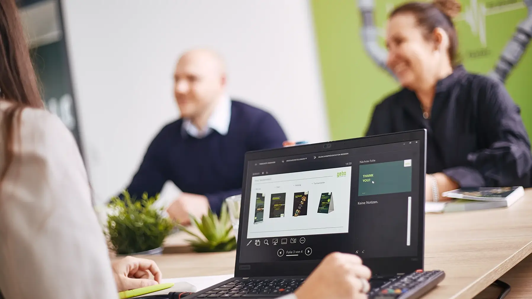 Two GEBO employees collaborating on laptop – career opportunities at GEBO Group Mettmann